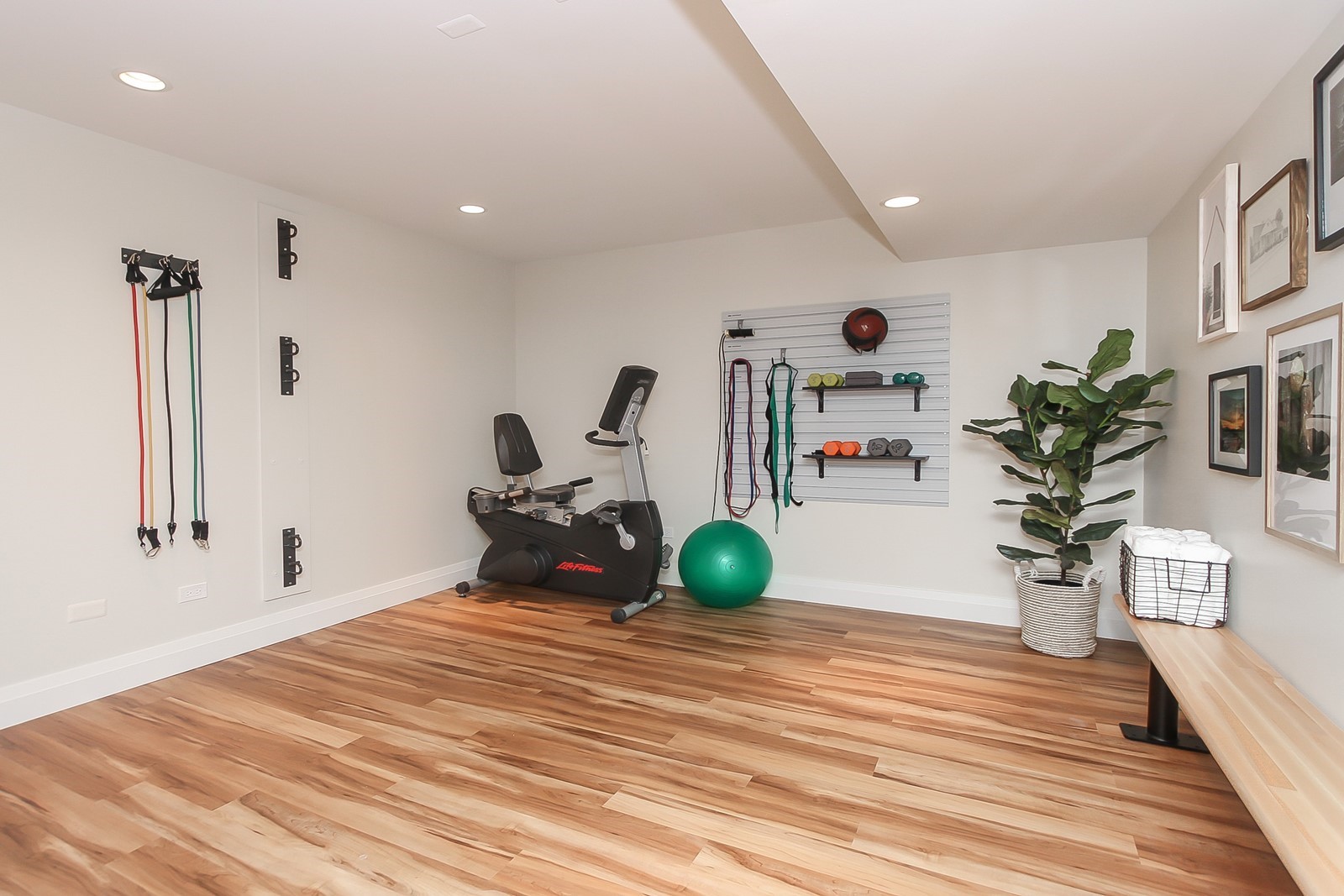 Basement Workout Area With Built-In Wood Bench and Equipment Storage