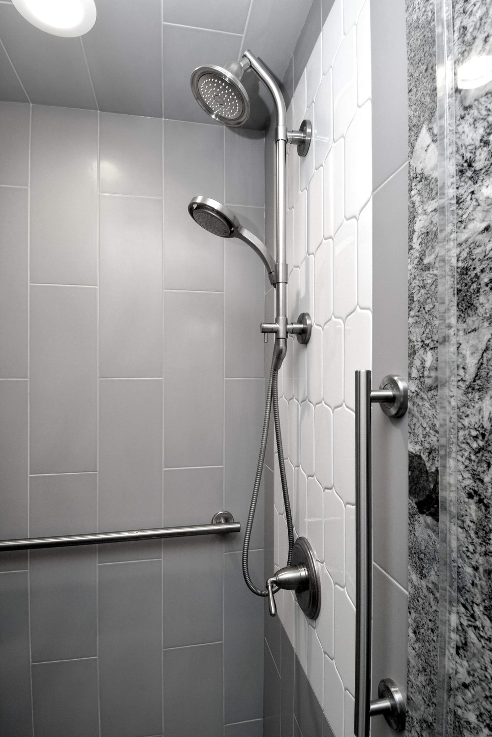 Gray Shower Tile with White Accent and Grab Bars