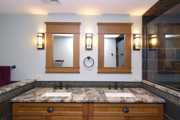 Craftsman bathroom vanity with double sinks next to shower