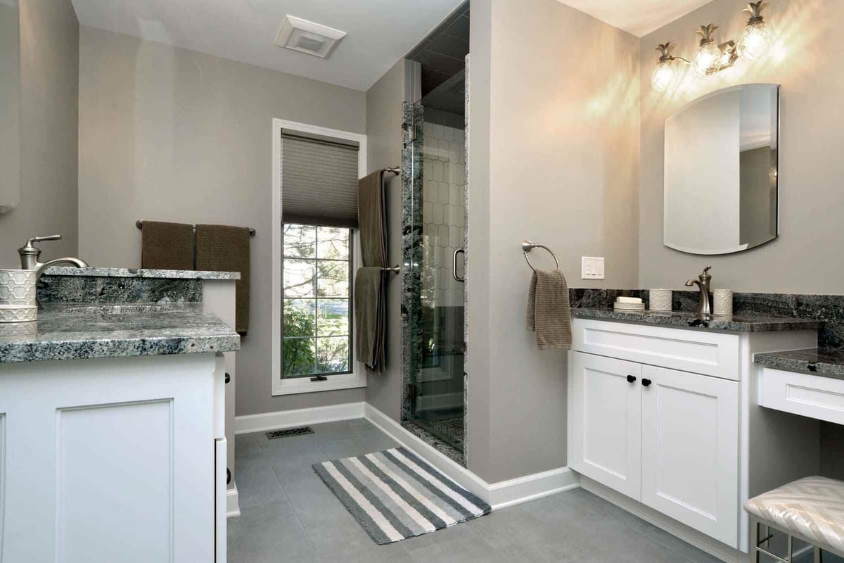 Upscale Gray Bathroom Addition With Walk-In Shower With Two Single Sink Vanities Facing Each Other