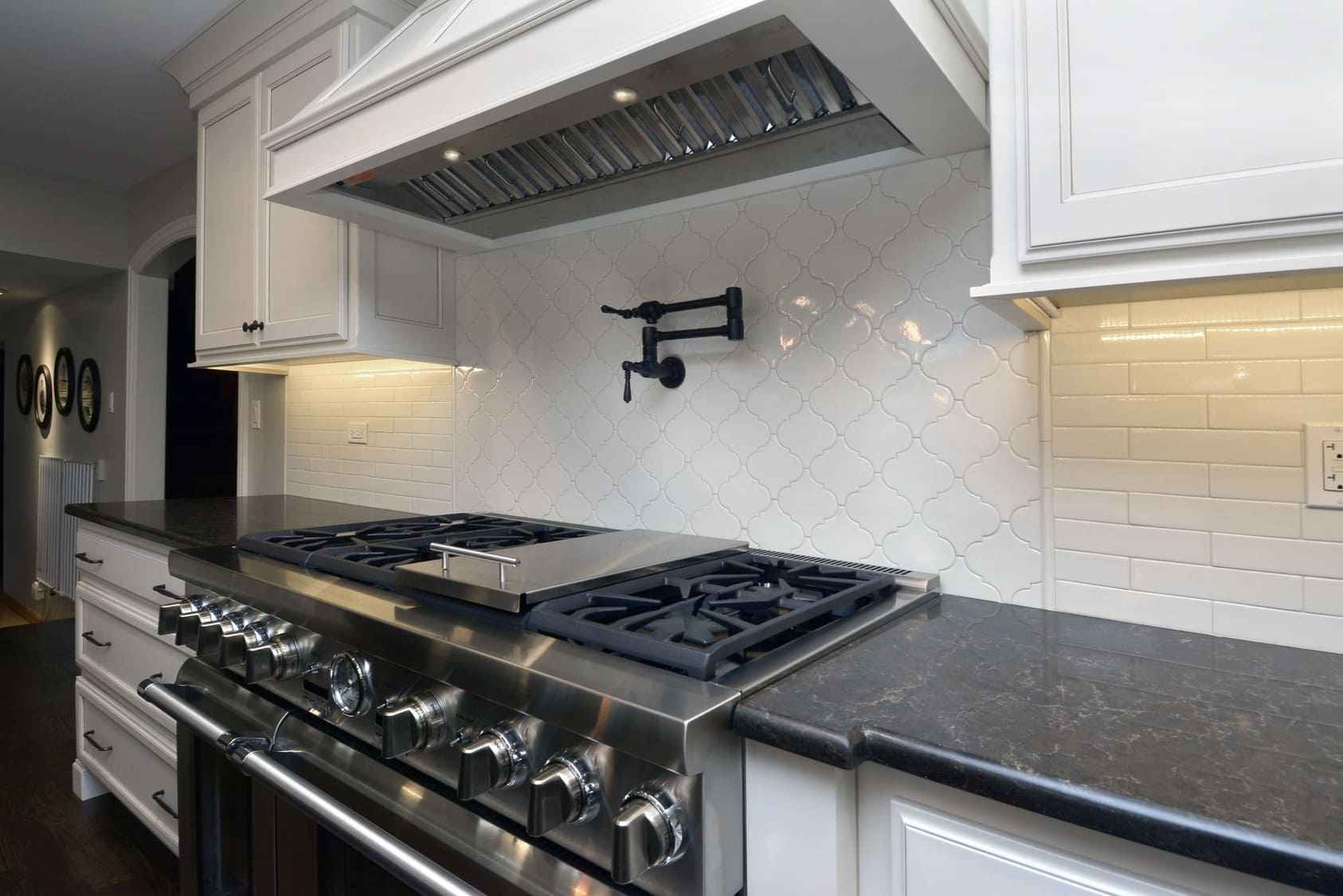High-End Stainless Steel Cooktop and Range Hood in Kitchen Remodel