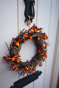 autumn themed wreath on door
