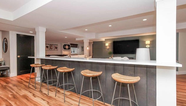 basement bar area with bar stools