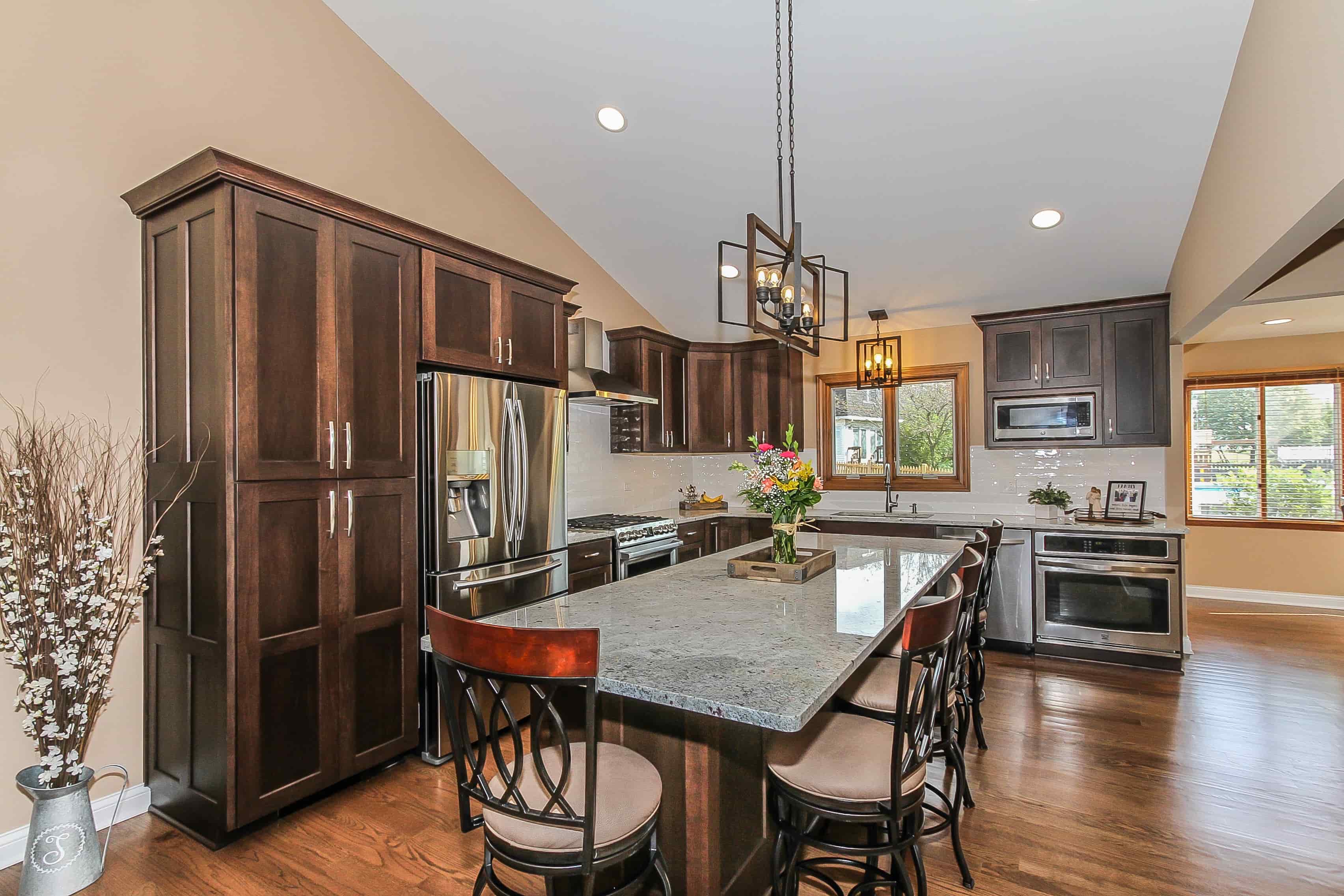 dark wood kitchen cabinets with pendant lighting in chicago kitchen remodel