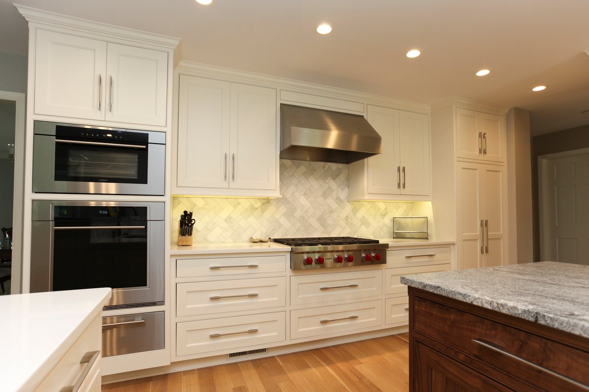 Double-range stainless steel oven in white kitchen remodel