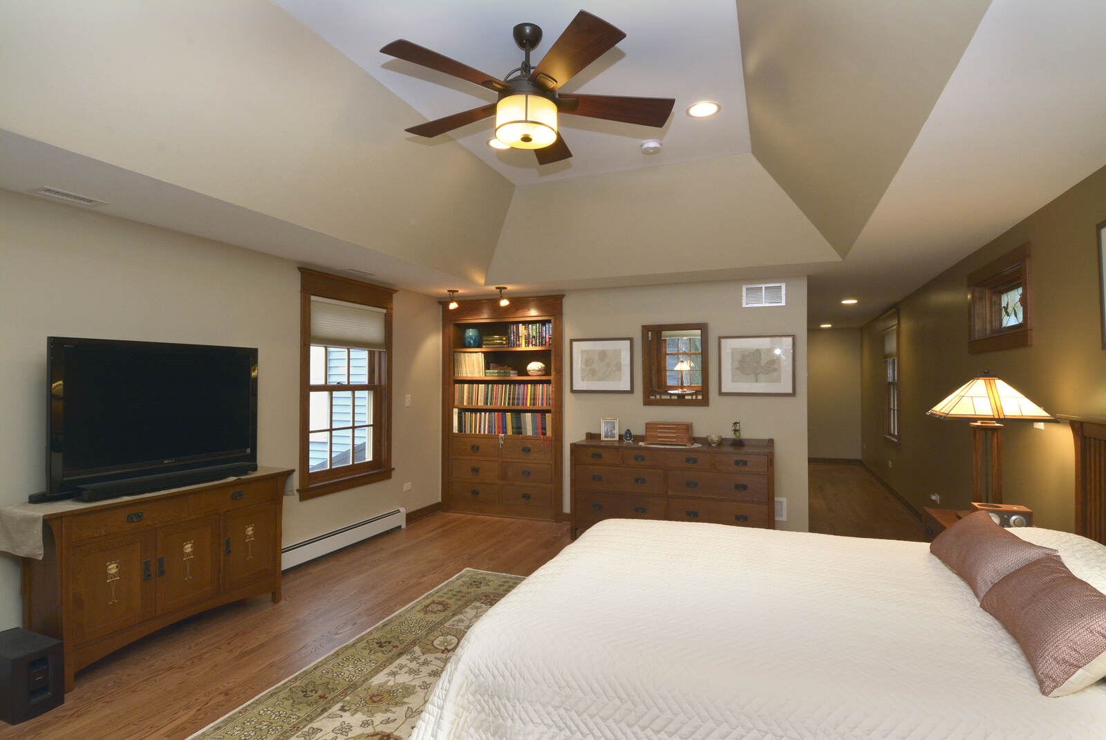 home addition master suite with bed and book shelf
