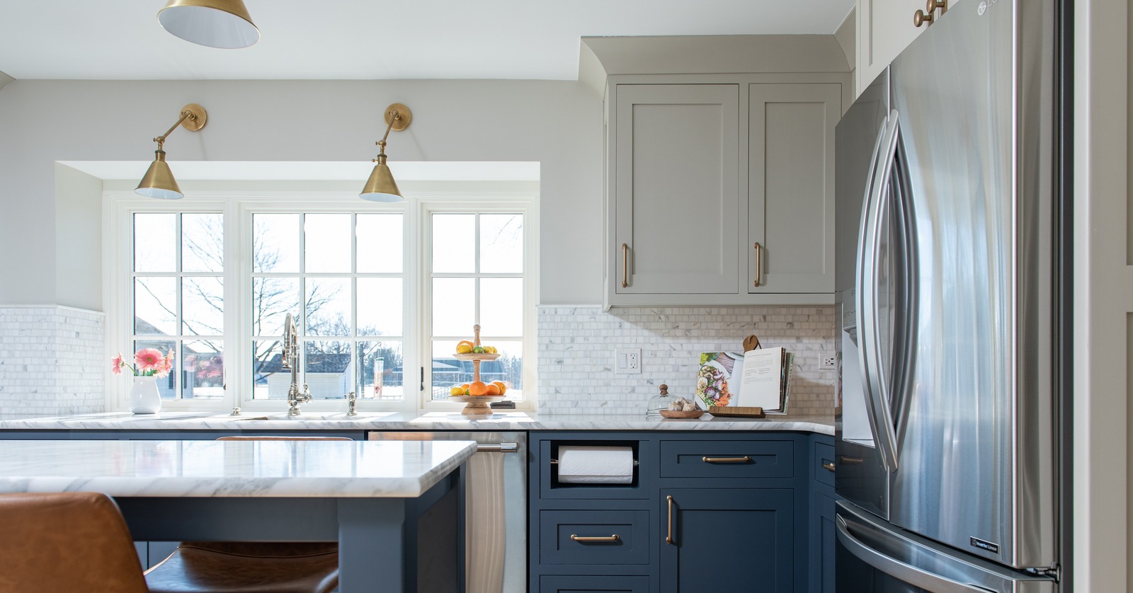 Custom kitchen layout highlighting refrigerator placement, food storage zone, marble island countertop, and brass hardware.