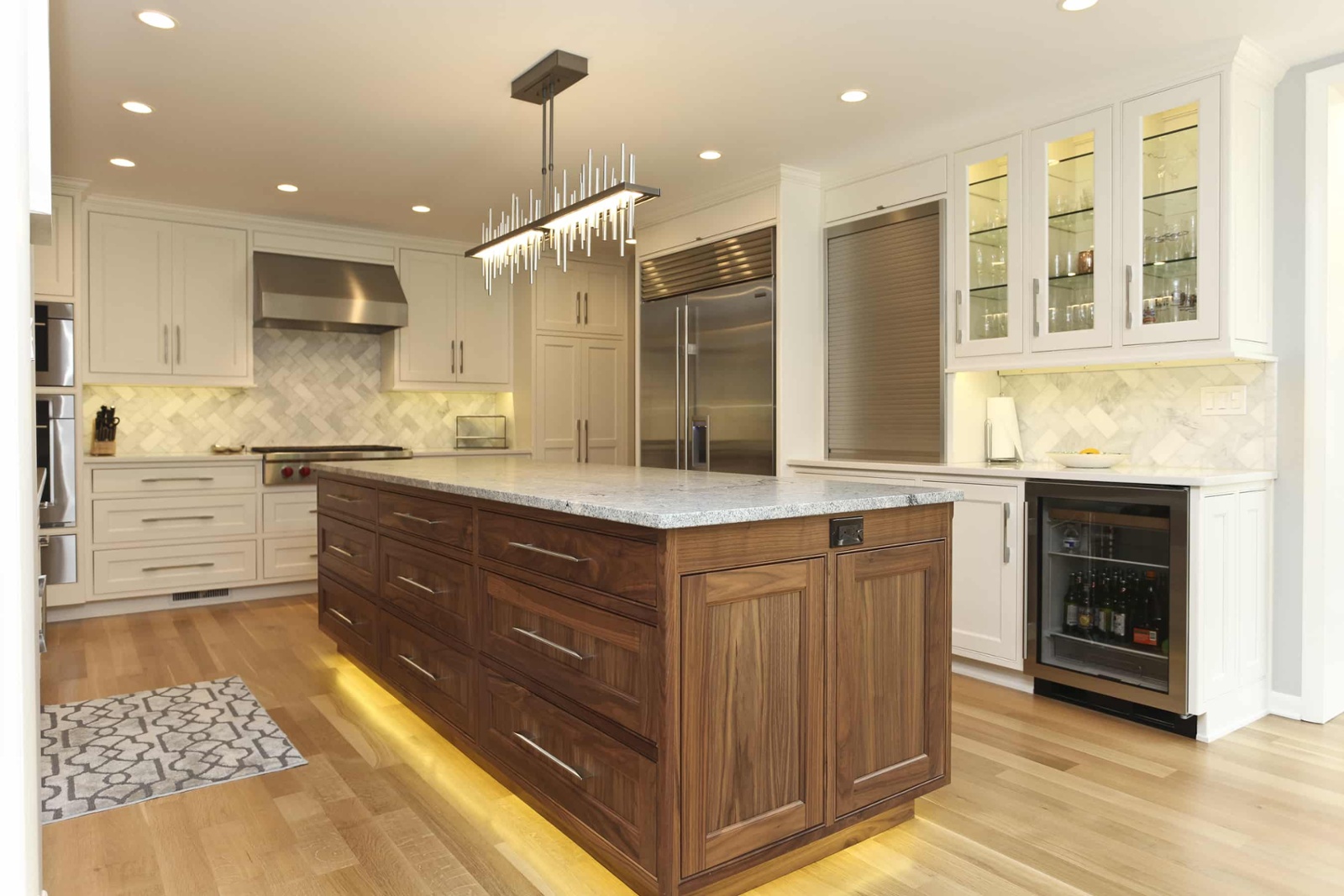 oak cabinets in kitchen with under cabinet lighting and marble kitchen island-1