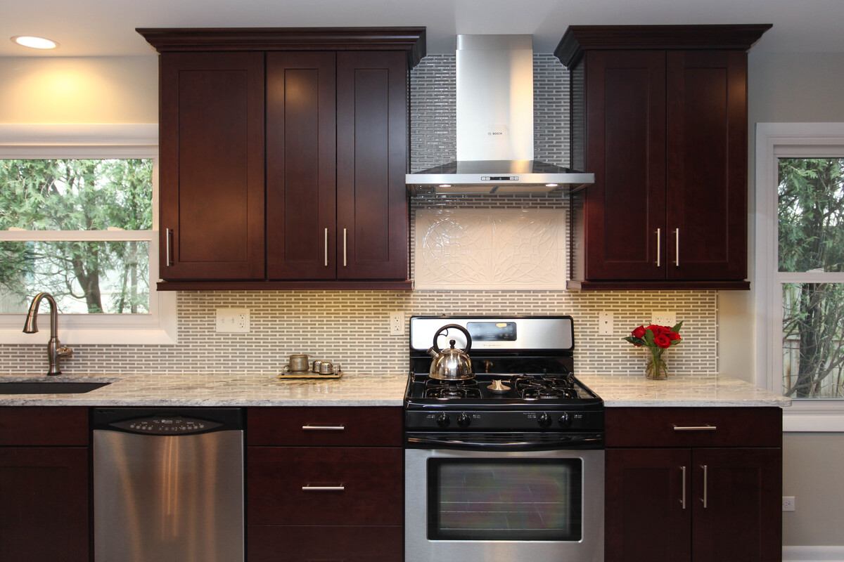 Modern kitchen remodel with stained cabinetry and stainless steel appliances