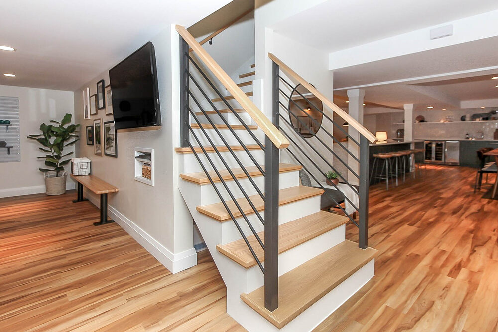 basement staircase with wood flooring