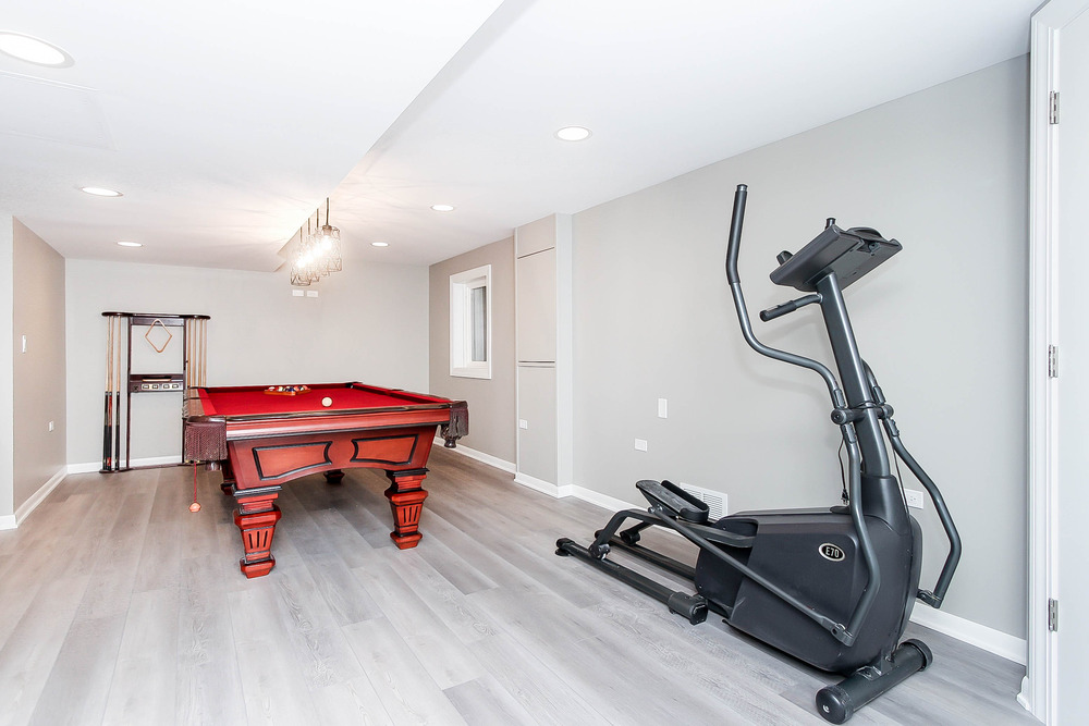 basement with exercise machine and pool table