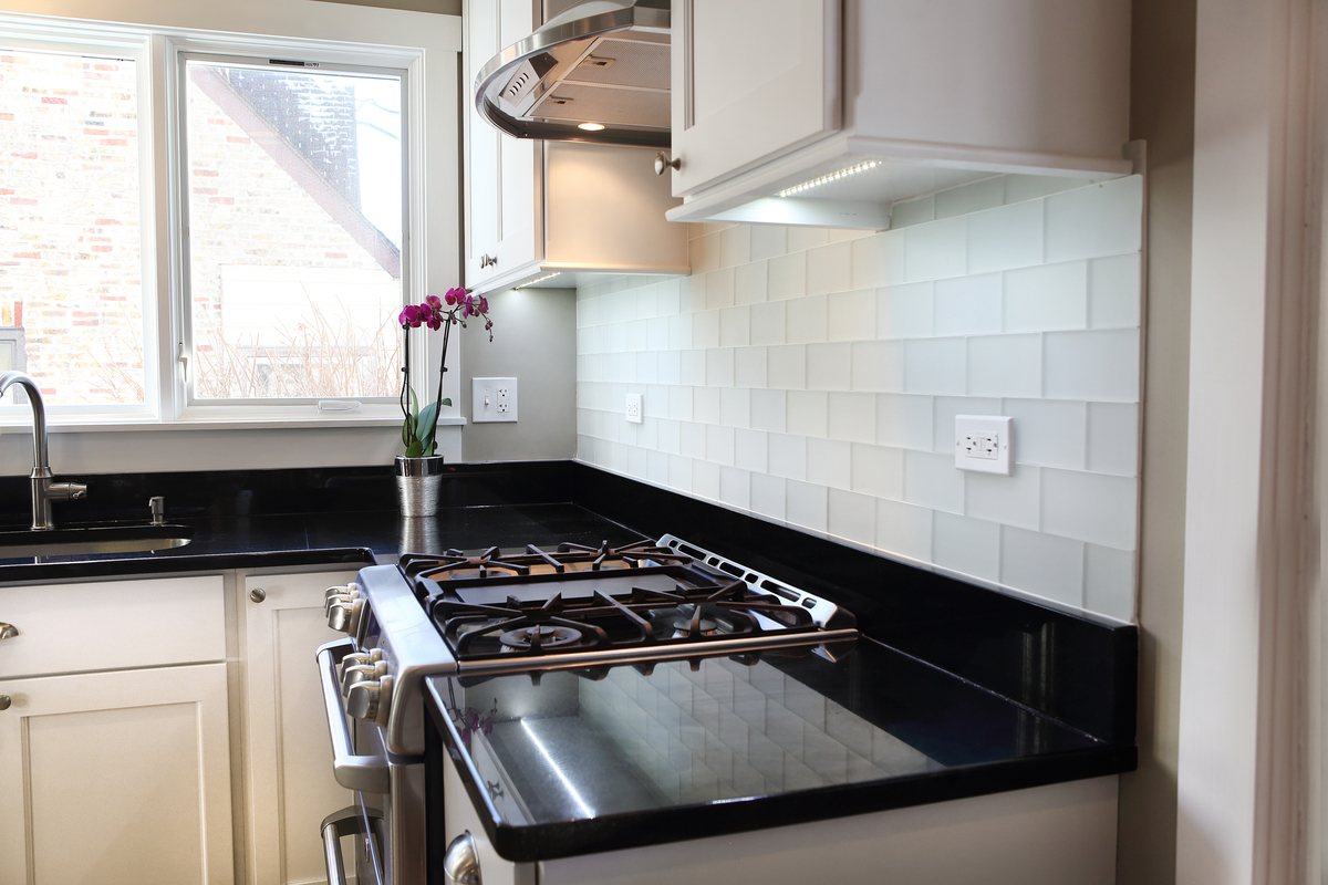 White tile kitchen backsplash behind oven
