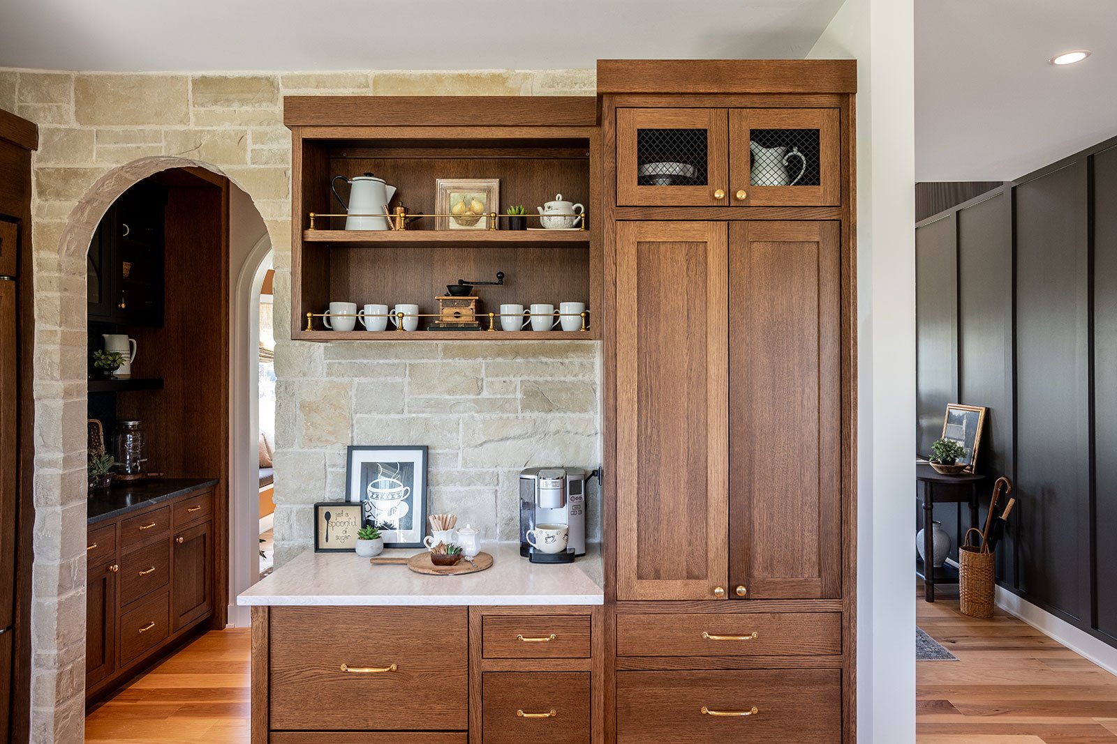 Custom kitchen work zone featuring a specialized beverage station and pantry storage to reduce traffic in the main cooking triangle.