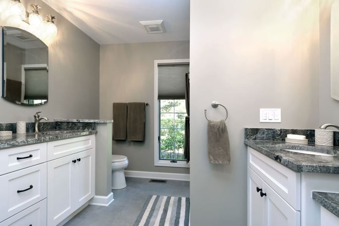 Large bathroom remodel with two sinks and white cabinets