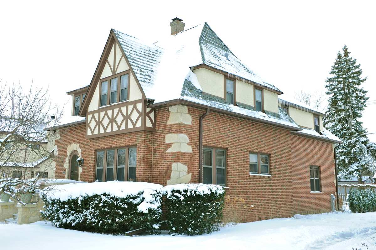 Rear home addition exterior on tudor style home