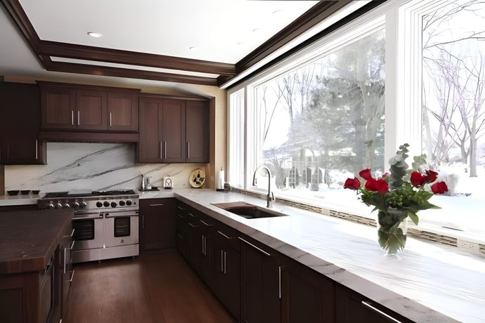 View of kitchen remodel with walnut cabinetry and large windows