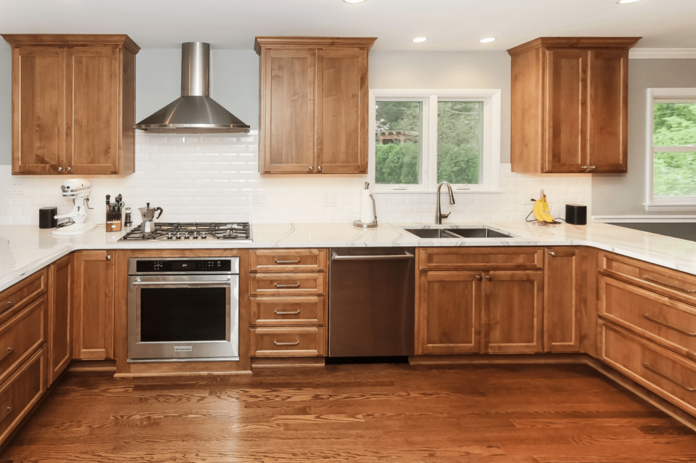 white kitchen backsplash with wall mounted range hood in chicago suburbs